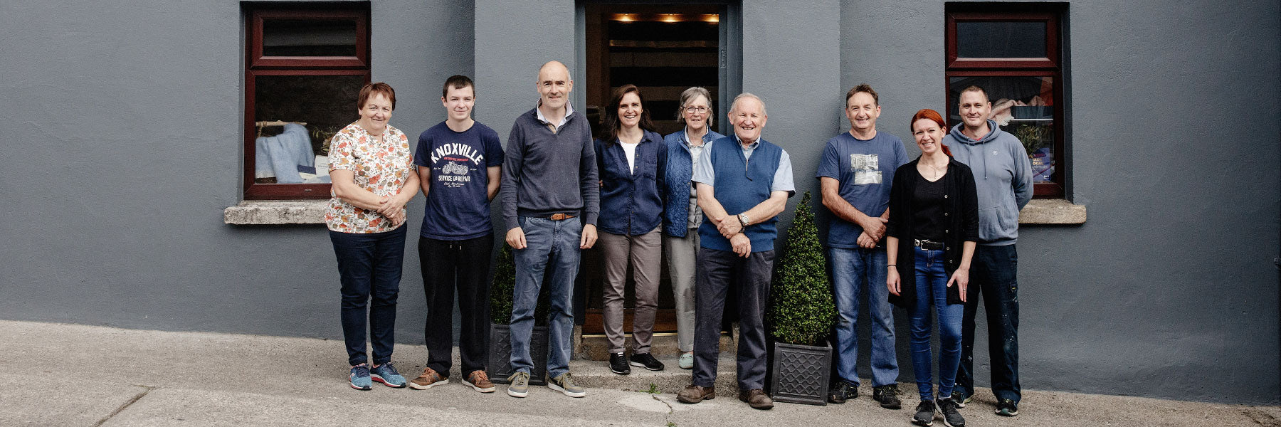 The Cushen family members standing in front of the mill