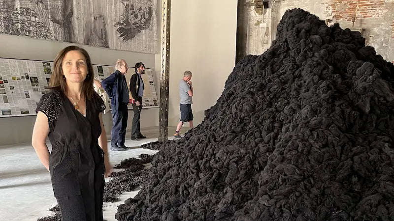 Miriam Cushen standing next to a sculpture of Skellig Michael, made from Cushendale Irish wool at the Venice Biennale 2023