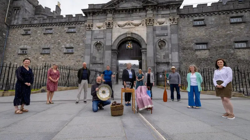 Members of MADE in Kilkenny standing apart with Kilkenny crafted items in front of Kilkenny Castle